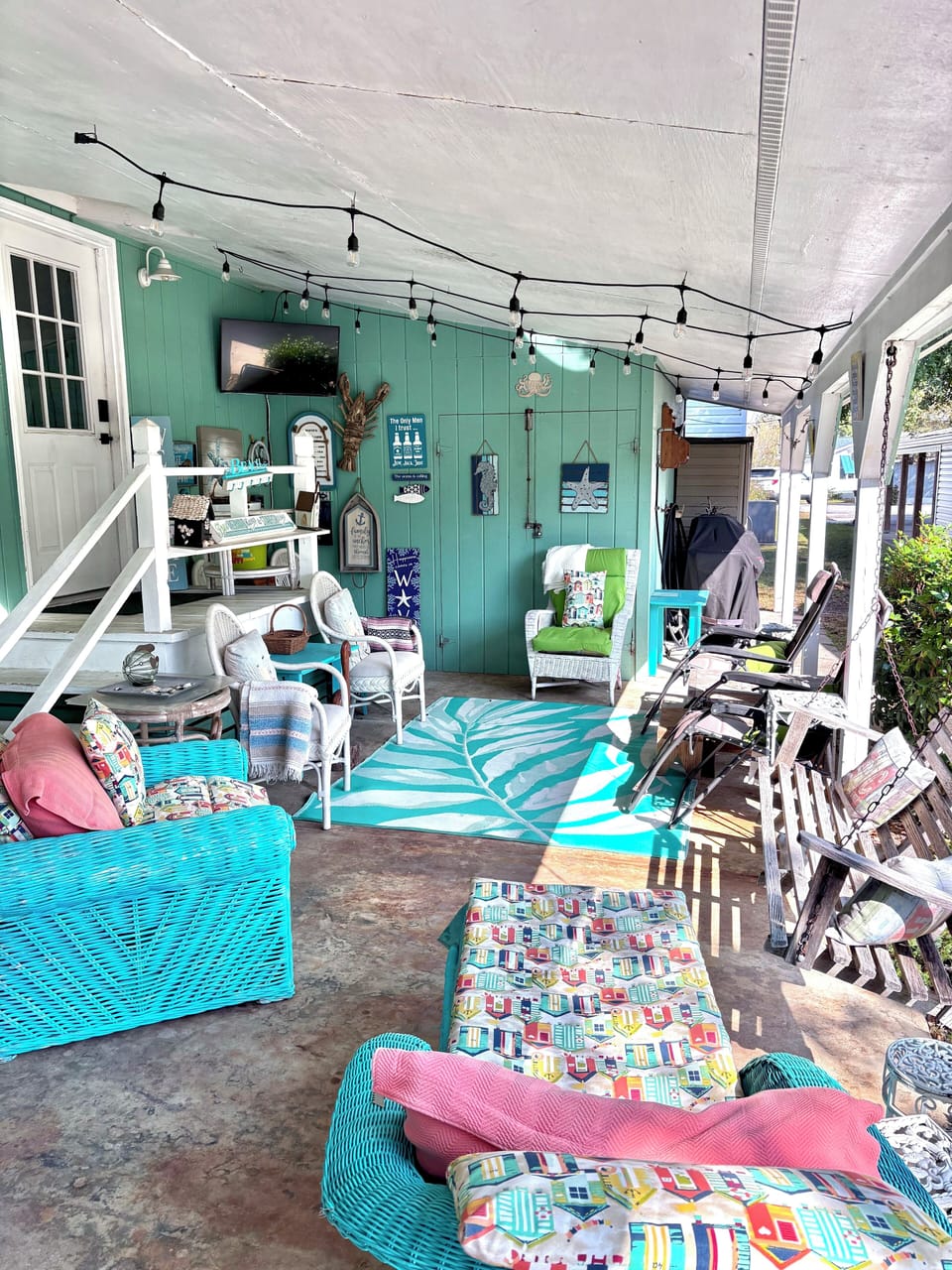 Outdoor room with tv and gas grill