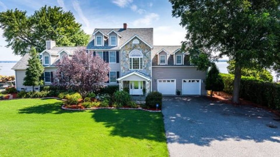 Acres of green grass lead you to the mansion on the water!