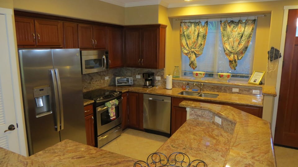 View of kitchen and granite counters.