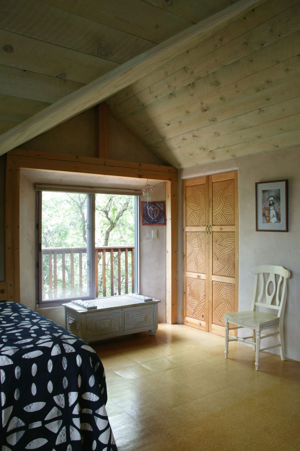 On the second floor, a queen bed in the spacious bedroom.