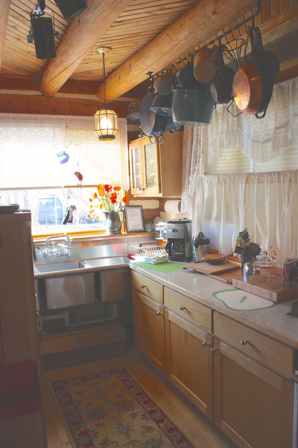 One view of the Kitchen with triple sink, stocked with pans for the easy Gourmet