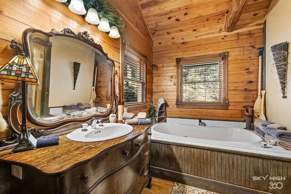 View of vintage vanity sink and open bath area.