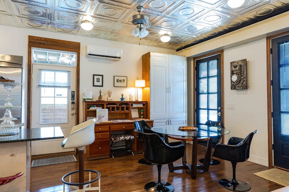 dining area, spacious work area/desk, side door to pool and side porch