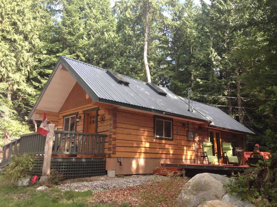 Large private side deck with BBQ, lounge chairs and table.