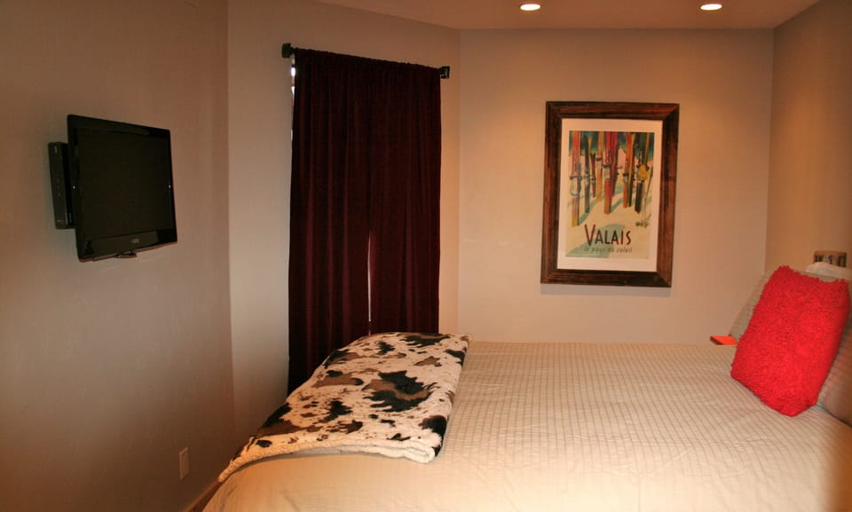 Beautiful bedroom with rustic log bed to snuggle into! 30 inch fat screen.