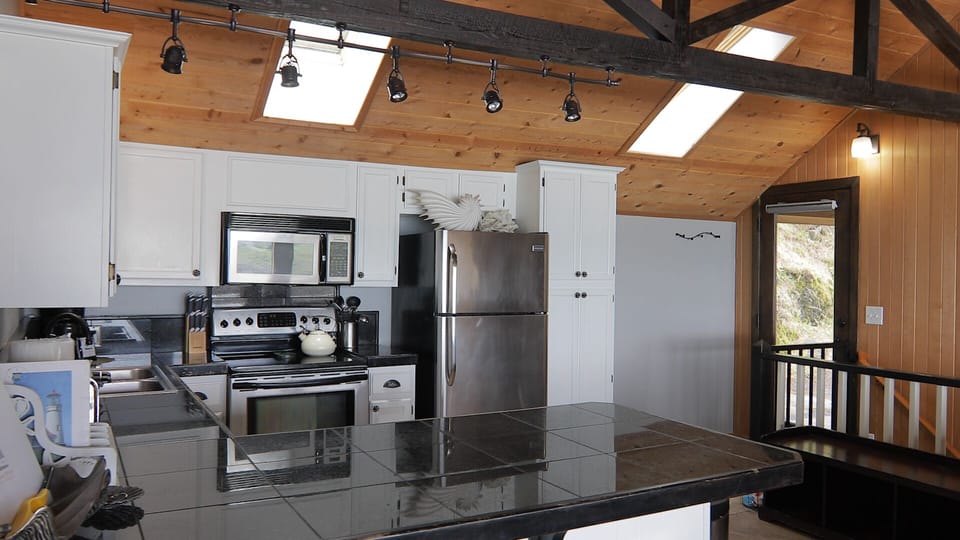 kitchen and breakfast bar on main floor and at main entrance