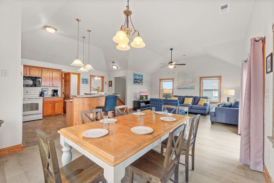 The 6-person dining table is conveniently adjacent to the kitchen, making mealtime a breeze.