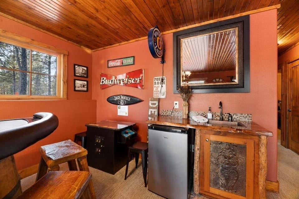 Lower level family room with gas fireplace, tv, card table, arcade game, wetbar