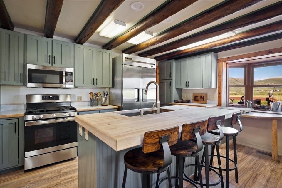 Large and fully stocked kitchen with industrial size fridge 