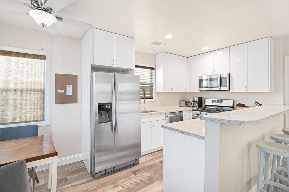 The kitchen opens up to a small eating area, in addition to the bar seating.
                