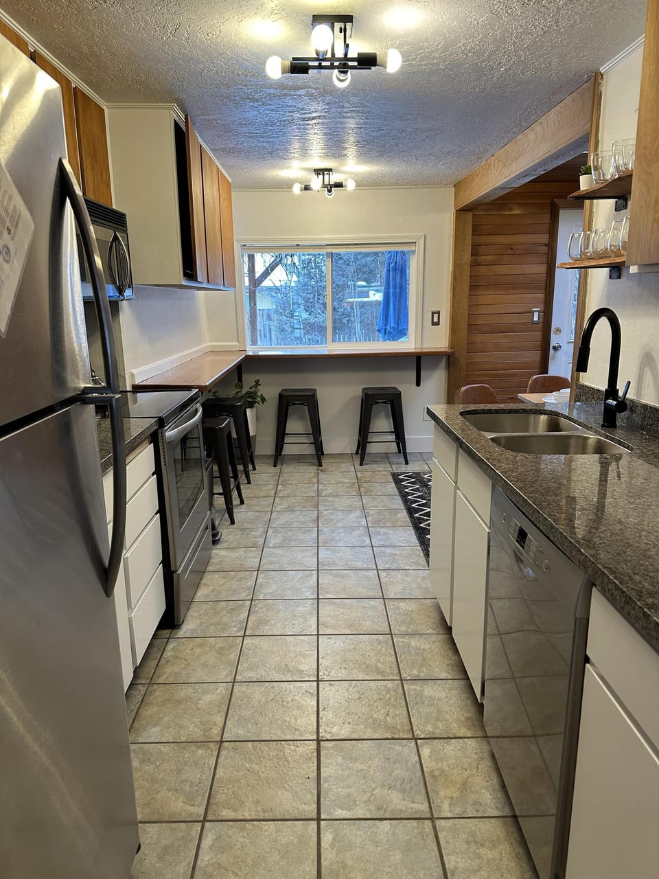 Fully furnished kitchen with breakfast nook overlooking the backyard