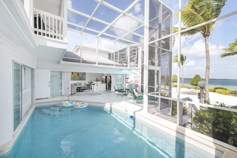 Private pool, fully screened in for comfort, just steps to the beach