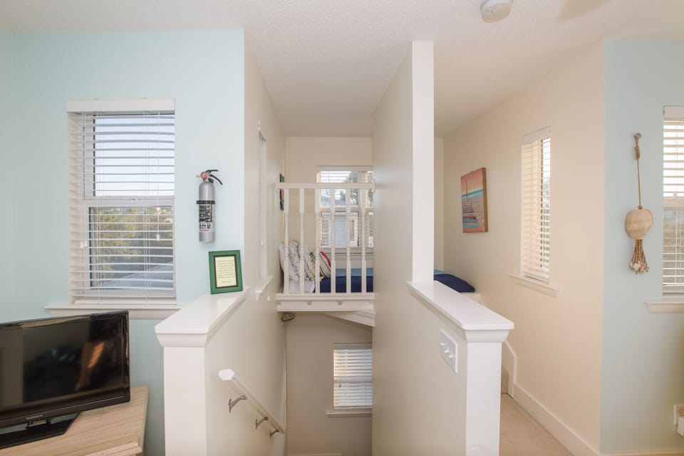 Tower room with one of two twin beds.