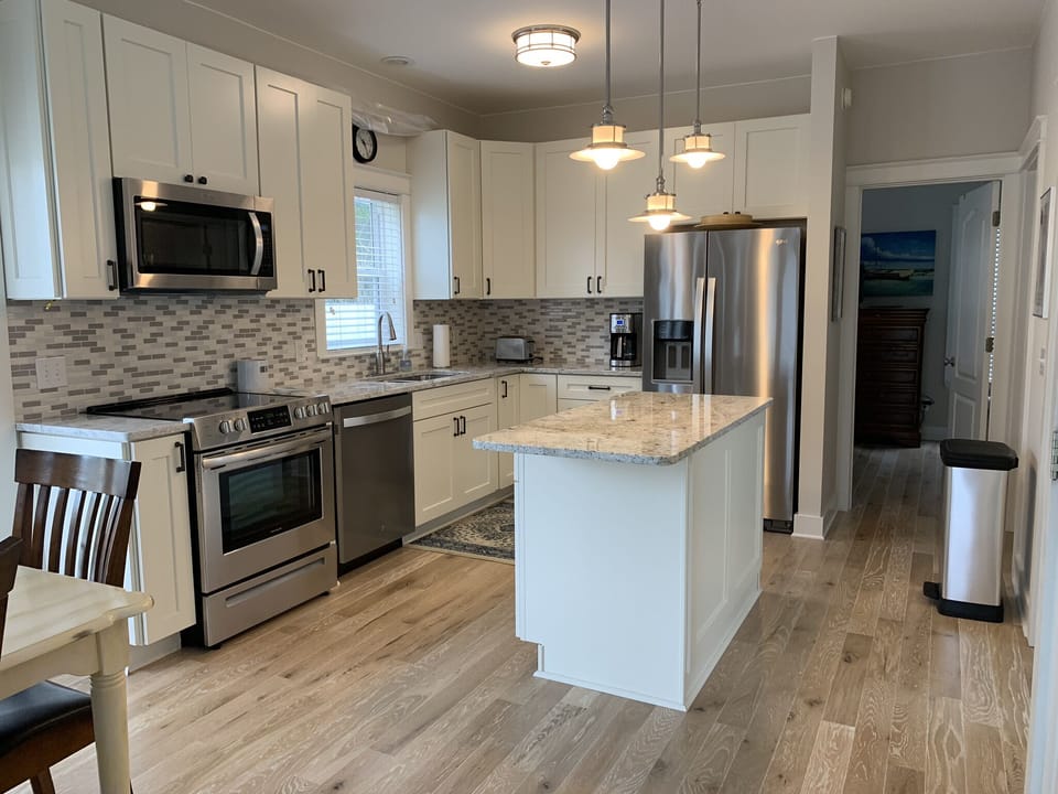 Newly renovated kitchen with granite tops and stainless steel appliances