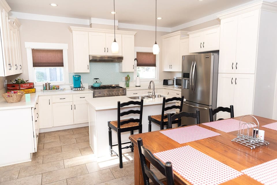 A beautiful and fully stocked kitchen with island, extra seating and 36" Cosco gas range.