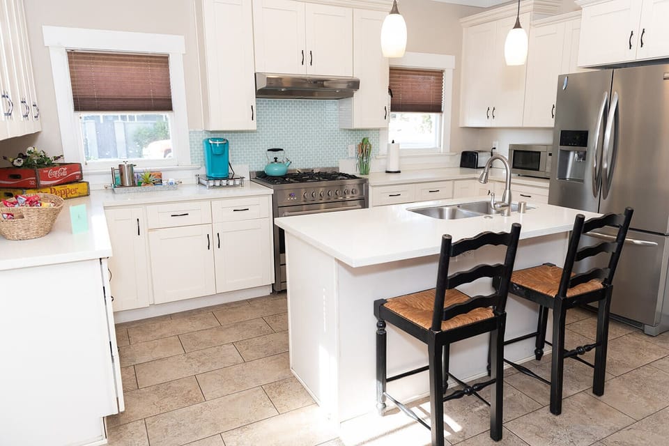 A beautiful and fully stocked kitchen with island, extra seating and 36" Cosco gas range.