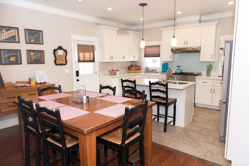 A large dining room table and extra bar seating in an open concept kitchen dining room area