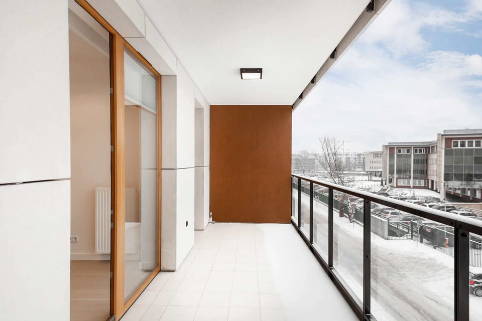 A balcony with a view of the snowy surroundings, offering a small outdoor space to enjoy the fresh air even during winter.