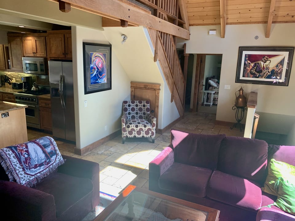 Living room, stairway down to garage, entry to Bedroom #2