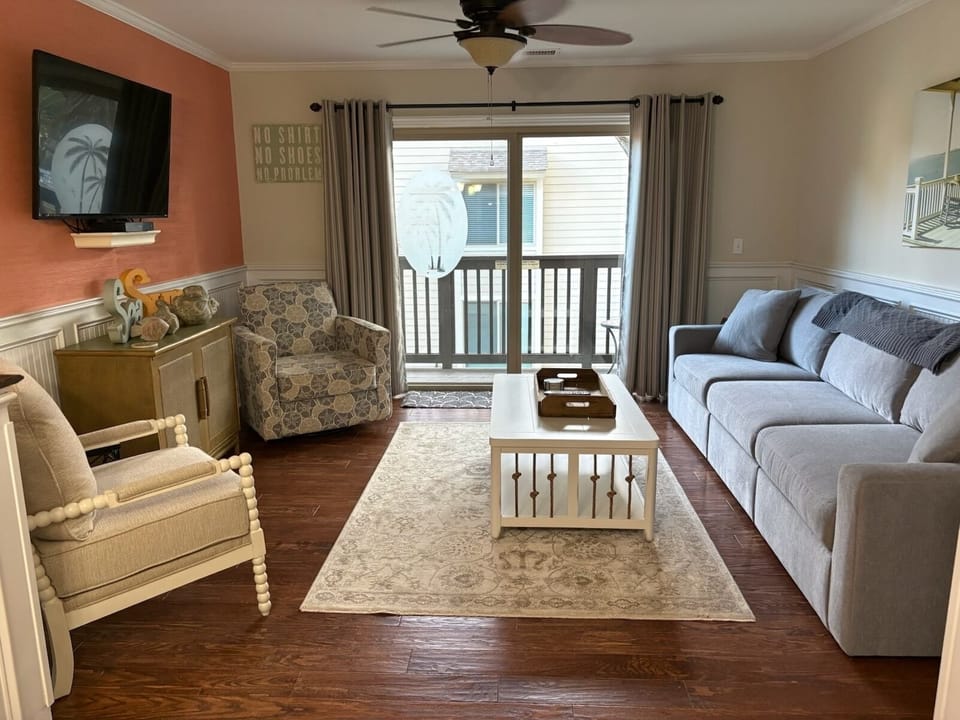 Living room with balcony over looking pool