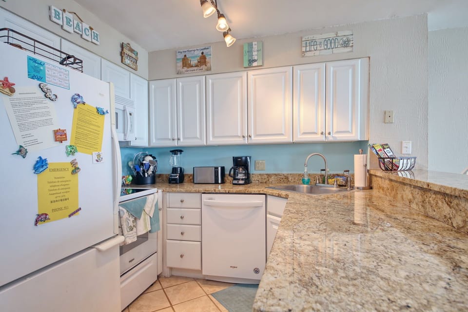 Kitchen with all essential tools for cooking and laundry.