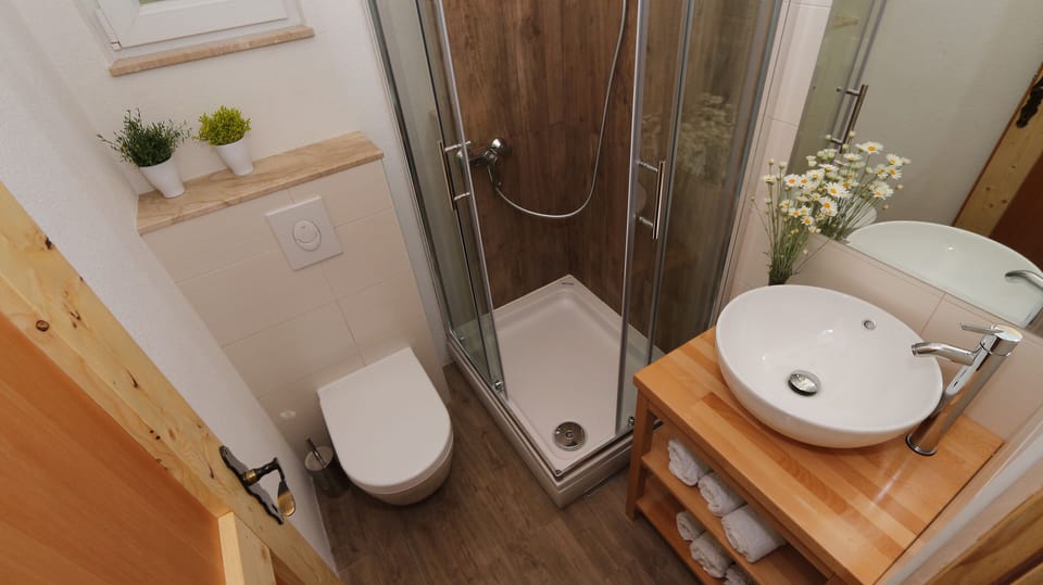One of two bathrooms equipped with a shower,a toilet and a sink
