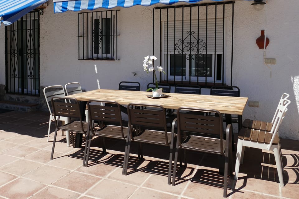 Large dining table by BBQ and pool - plenty of space for 12 people, sun or shade