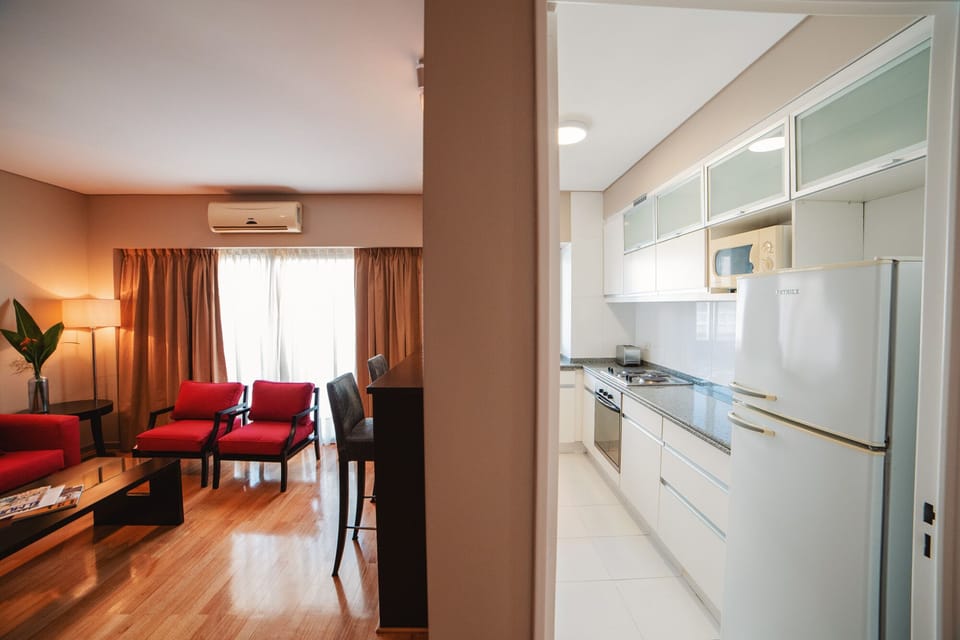 Senior Suite | Living area | 42-inch Smart TV with cable channels, TV