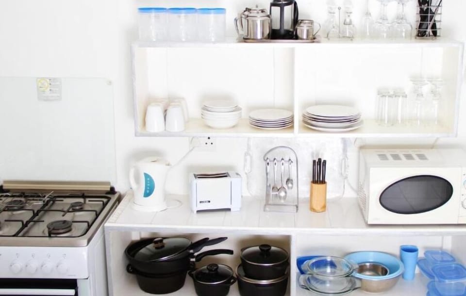 Fridge, stovetop, electric kettle, cookware/dishes/utensils