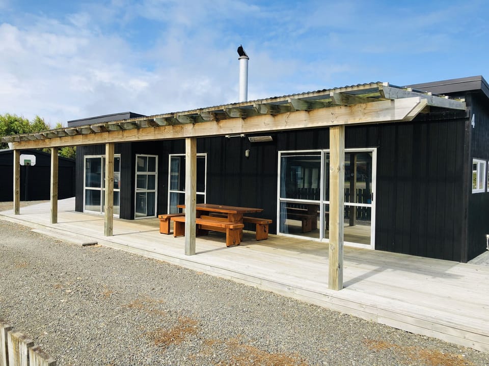 Large covered deck with seating and BBQ