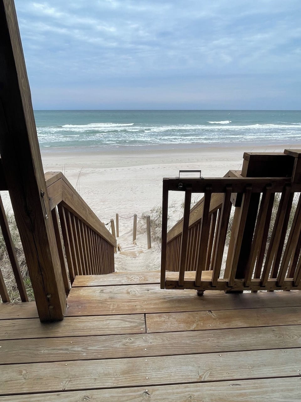 Stairs from the lower deck down to a landing have you on the beach in moments.