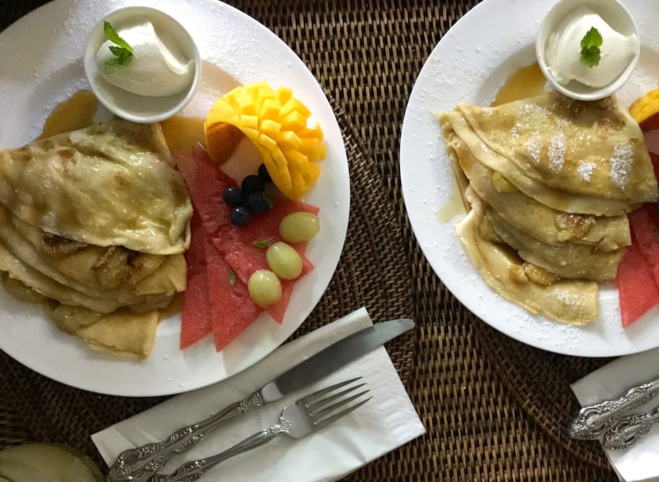Banana crepes, yoghurt and fresh fruit with maple syrup   