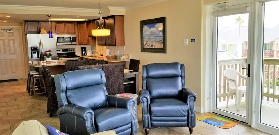 Two navy leather armchairs face the beach
