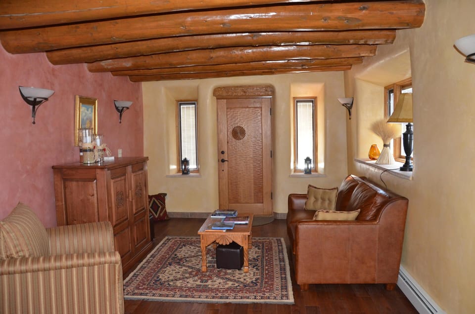 Living room with Spanish colonial furniture and door - original vigas