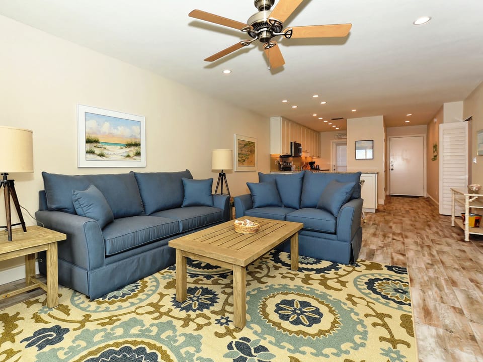 Spacious living room with view out to Lanai, the beach and azure waters of the Gulf of Mexico...large HDTV, stereo, and more...