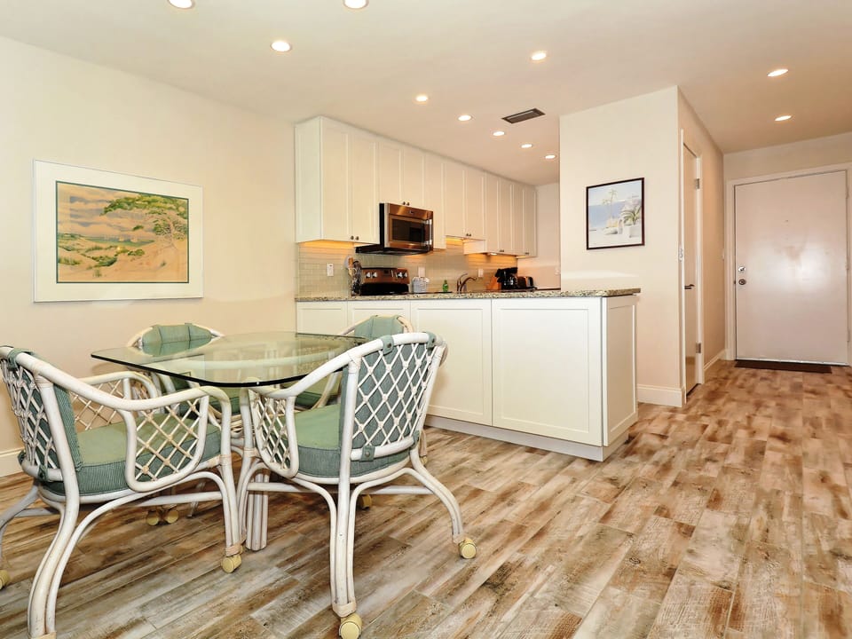 The dining room table is right off the kitchen with seating for four