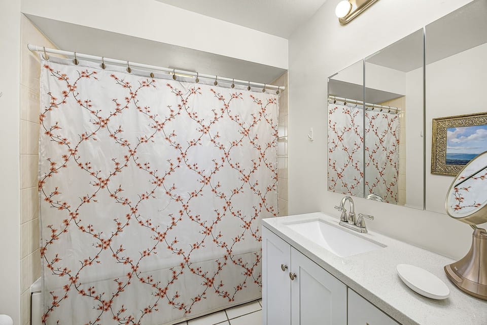 The primary bathroom has a shower/tub combo with a privacy window for additional light