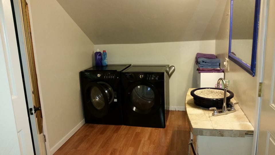 Frontload washer & Dryer in upstairs bathroom. Bedroom door to the left.