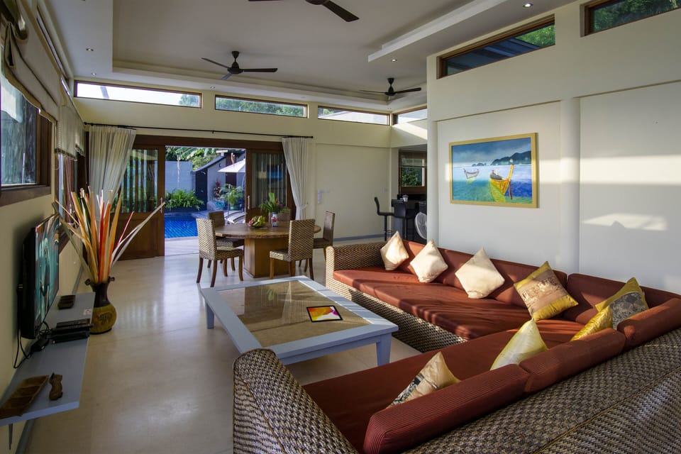 Living area features a spacious layout with large L-shaped sofa & SMART TV