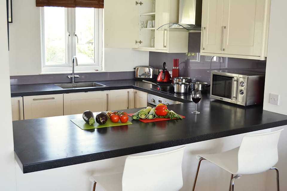 Ground floor: The well equipped U-shaped kitchen with breakfast bar and stools