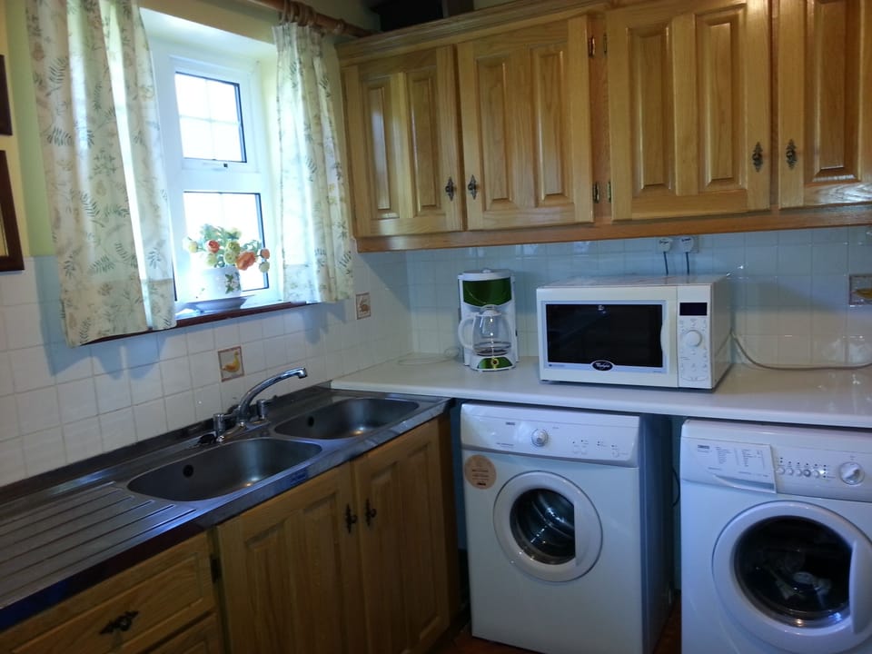  LAUNDRY Washing machine,  tumble dryer, iron .& board and
 Microwave Oven
