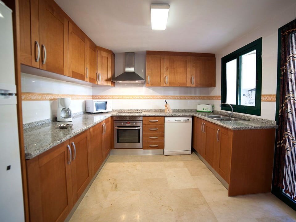 Countertop, Room, Property, Cabinetry, Kitchen, Furniture, Building, Floor, Major Appliance, Kitchen Stove