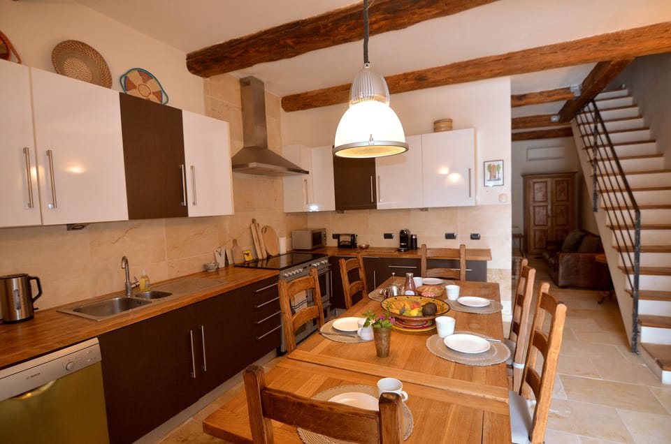 Kitchen with dining table and stairs to first floor