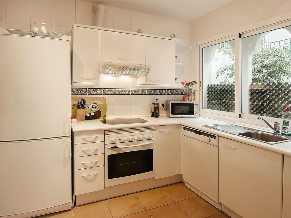 Room, Cabinetry, Kitchen, Property, Furniture, Countertop, Major Appliance, Kitchen Stove, Interior Design, Building