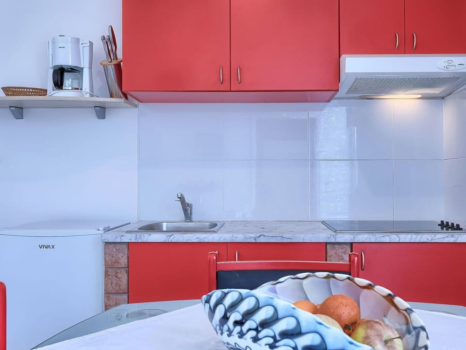 Countertop, Room, Red, Kitchen, Property, Cabinetry, Orange, Furniture, Tile, Interior Design
