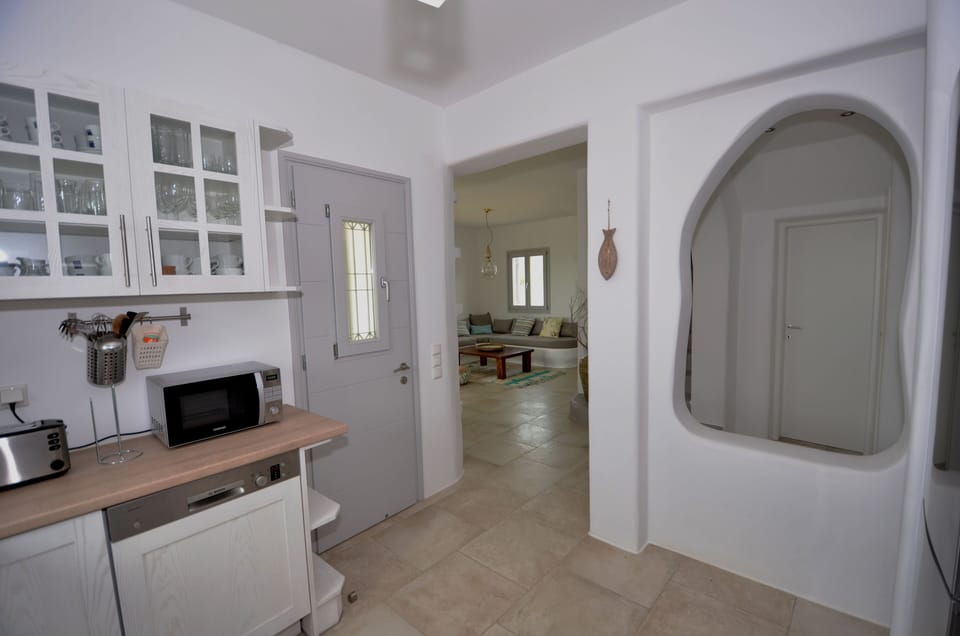 The open kitchen is fully equipped with household appliances.