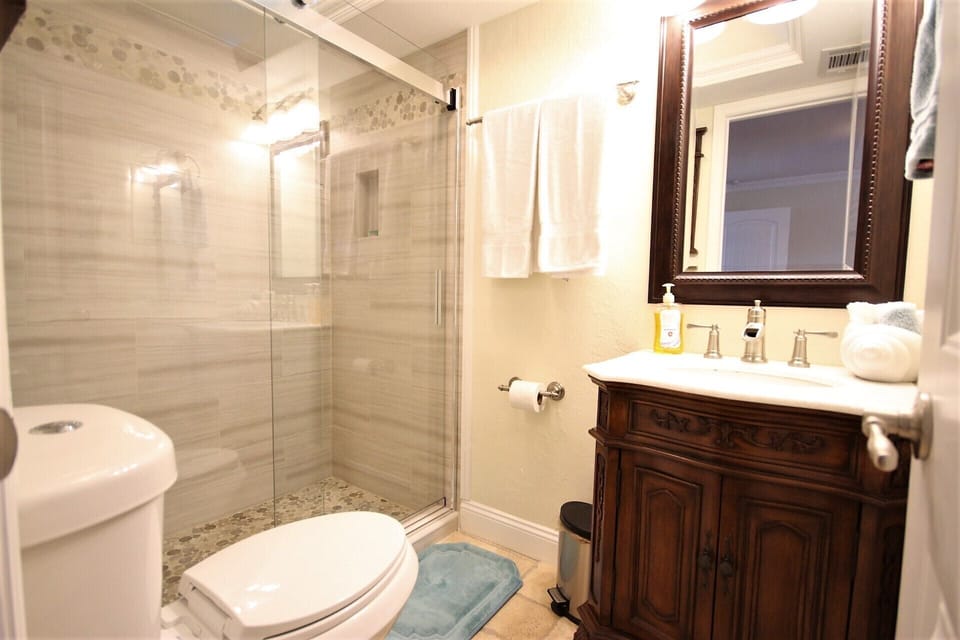 Though small, the primar bathroom is elegant with a high end vanity & new shower
