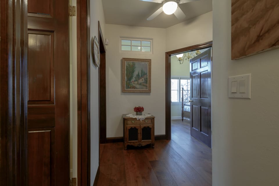 Upstairs hallway from top of stairs; doors to guest bedrooms at left and ahead