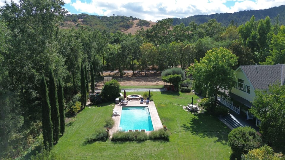 View southwest across rear of estate.  Pool, spa, and bocce court just past spa.