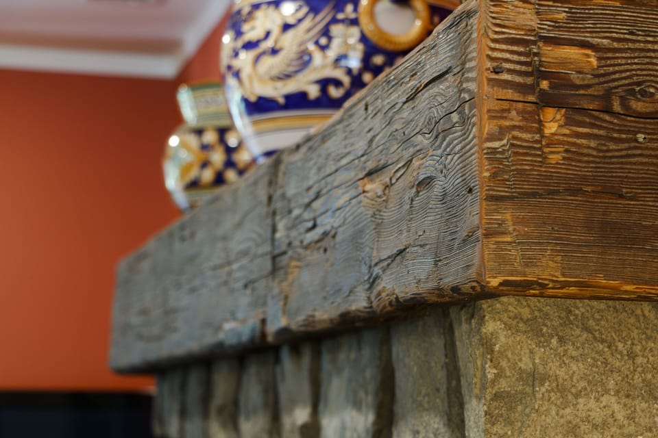 Hand-hewn beam from century-old barn reclaimed for mantel piece 